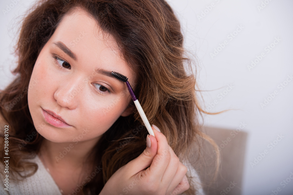 Portrait of a Caucasian young woman doing makeup. Portrait of a Caucasian young woman doing makeup.