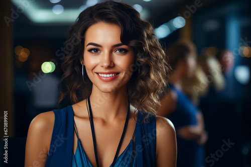 Woman with smile on her face and blue dress.