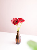 A Brown Vase with Gerbera Flowers.