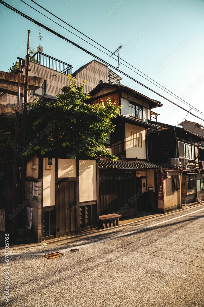 a row of asian buildings with electrical cables running overhead a row of asian buildings with electrical cables running overhead