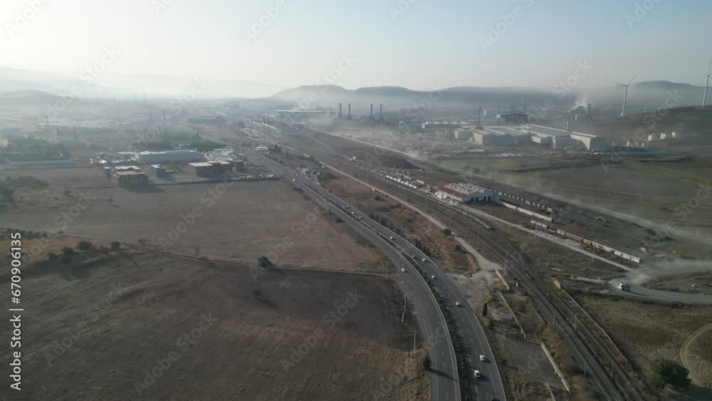 City area with industry, windmills, traffic, roads and chaos