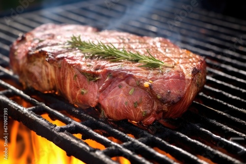 close-up of a medium-rare ribeye steak on a grill