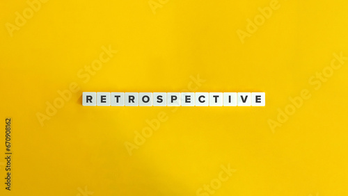 Retrospective Word on Letter Tiles on Bright Orange Background. Minimal Aesthetic. photo