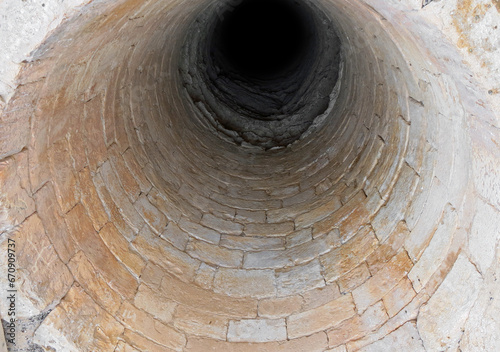 tunnel or a bottomless pit made of rocks and stones