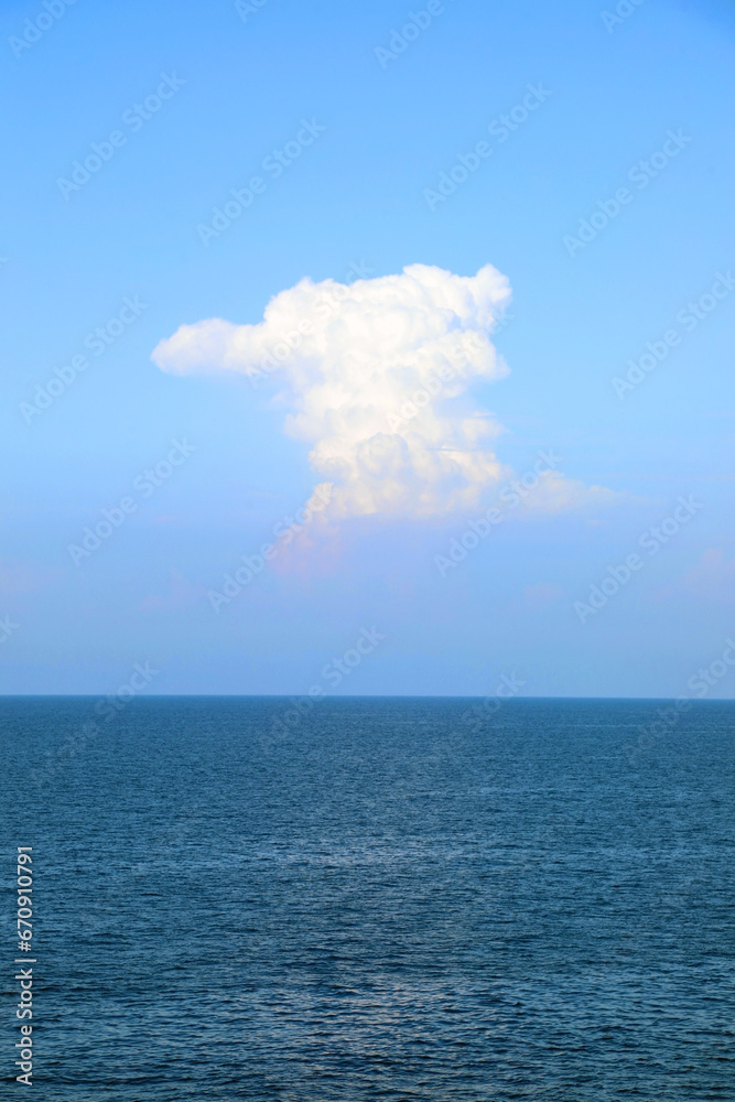 white cloud in the blue sky and under the sea without boats or ships