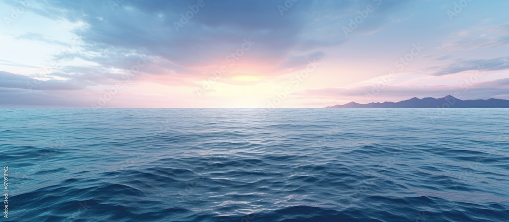 Dusk can be observed on the opposite side of the expansive ocean