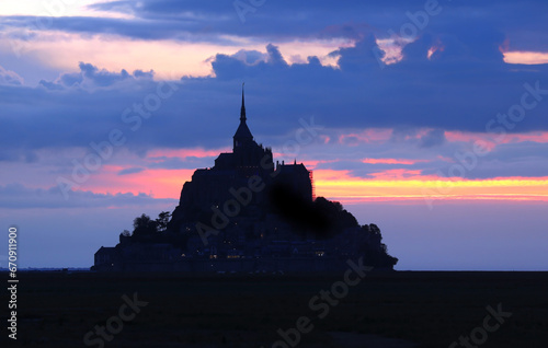 Enchanting Sunset Silhouette of Mont Saint-Michel Abbey on the French Coastline