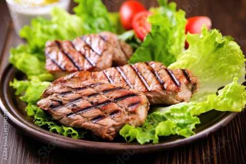 grilled chops on a bed of lettuce leaves