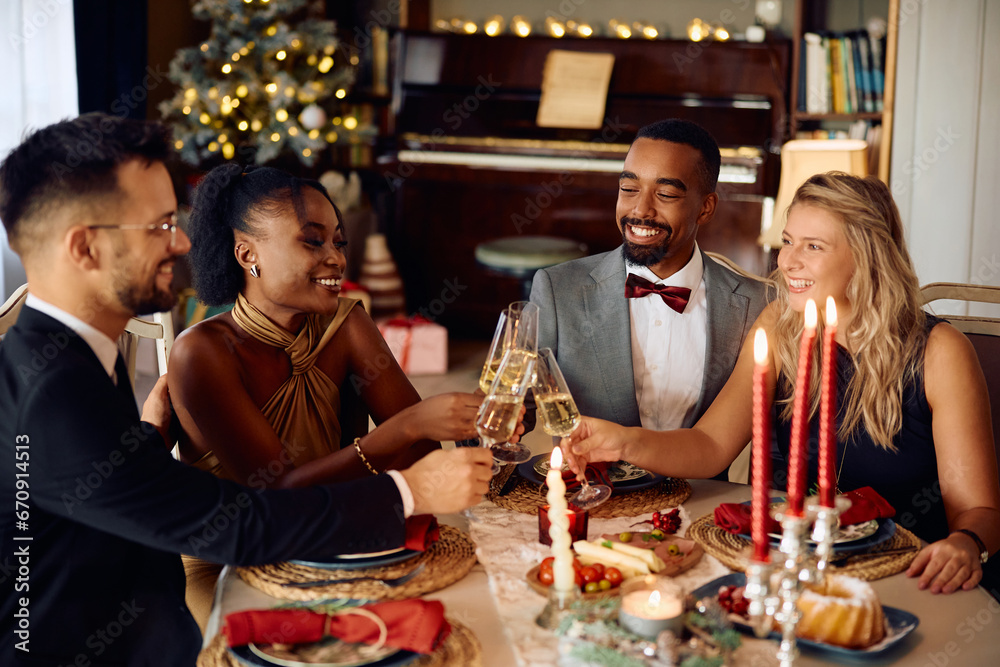 Group of happy friends toasting with champagne while celebrating during Christmas dinner at dining table. Group of happy friends toasting with champagne while celebrating during Christmas dinner at dining table.