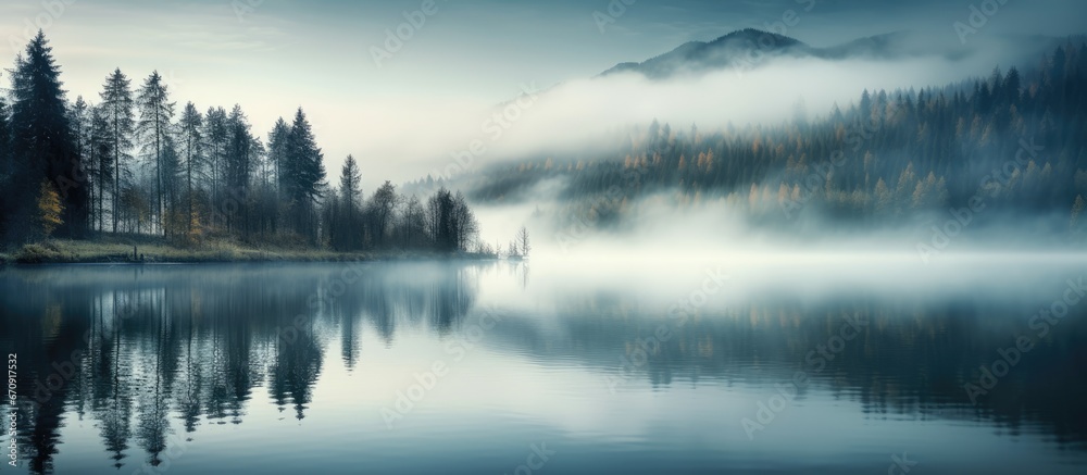 Fototapeta premium Enigmatic mist above woodland waters