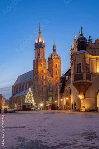 St Mary's church and Cloth Hall on snow covered Main Square in winter Krakow, illuminated in the night.