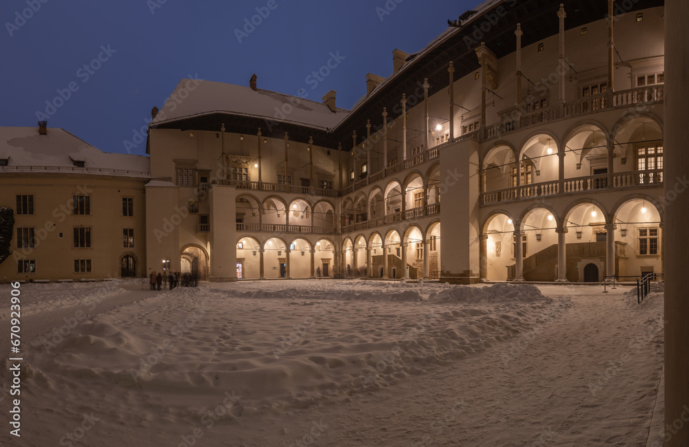 Arcaded courtyard of the Wawel Castle former foryal residence, fine example of renaissance architecture, winter snowy night, Krakow, Poland