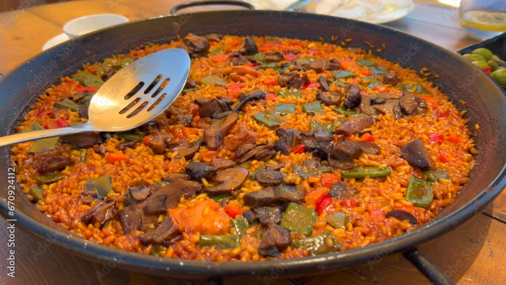 Traditional Spanish Paella dish with vegetables in a restaurant, tasty cooked rice with vegetables, Marbella Spain, 4K shot Traditional Spanish Paella dish with vegetables in a restaurant, tasty cooked rice with vegetables, Marbella Spain, 4K shot