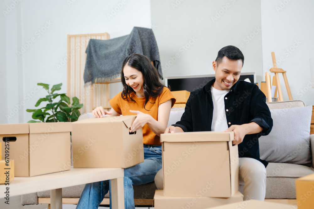 Happy asian young attractive couple man and woman with big boxes moving into a new house, new apartment for couple the new home, Moving house. Happy asian young attractive couple man and woman with big boxes moving into a new house, new apartment for couple the new home, Moving house.