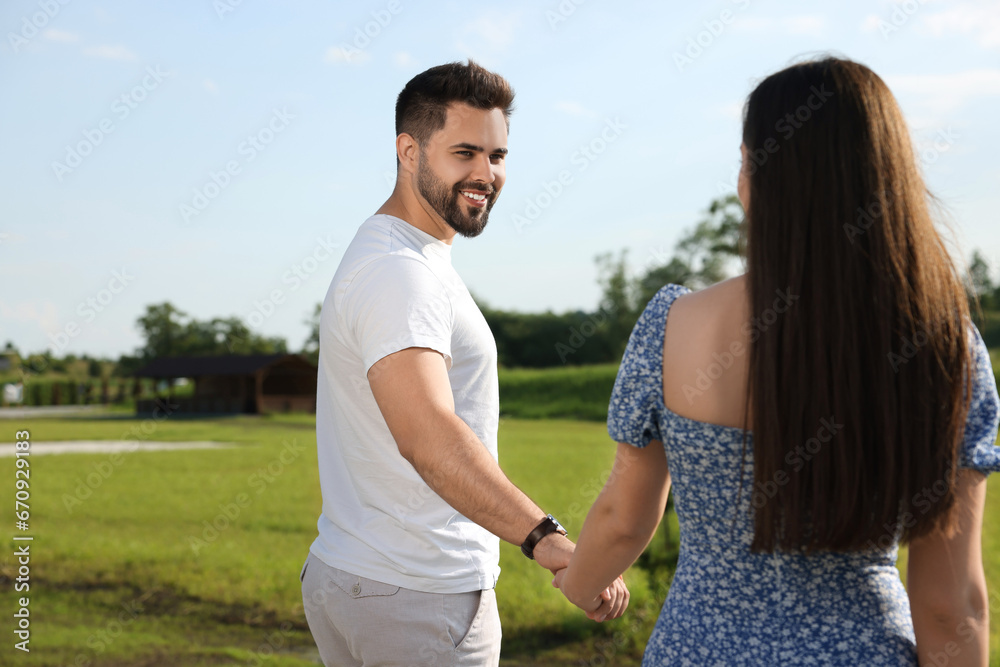 Romantic date. Beautiful couple walking outdoors on sunny day Romantic date. Beautiful couple walking outdoors on sunny day