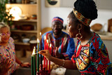 Side view of young African American woman in ethnic apparel burning candles symbolizing seven main principles of national culture