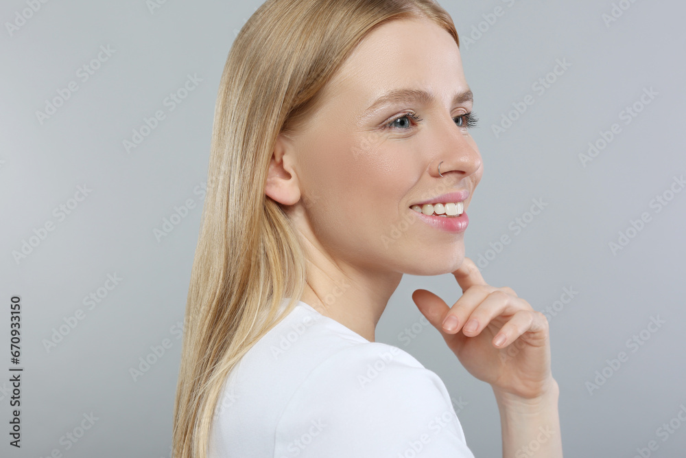 Portrait of beautiful young woman on grey background Portrait of beautiful young woman on grey background