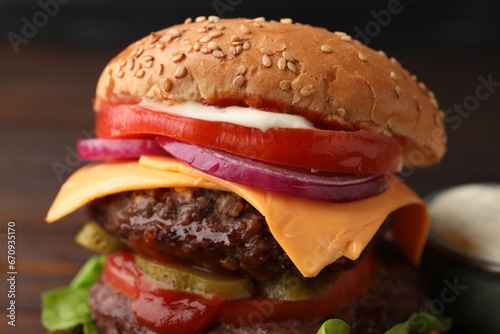 Tasty cheeseburger with patties, onion and tomato, closeup
