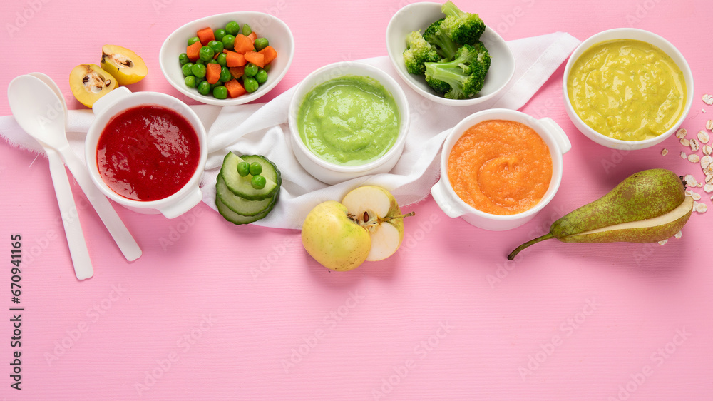 Bowls with baby food on pink background. Healthy eating concept. Bowls with baby food on pink background. Healthy eating concept.