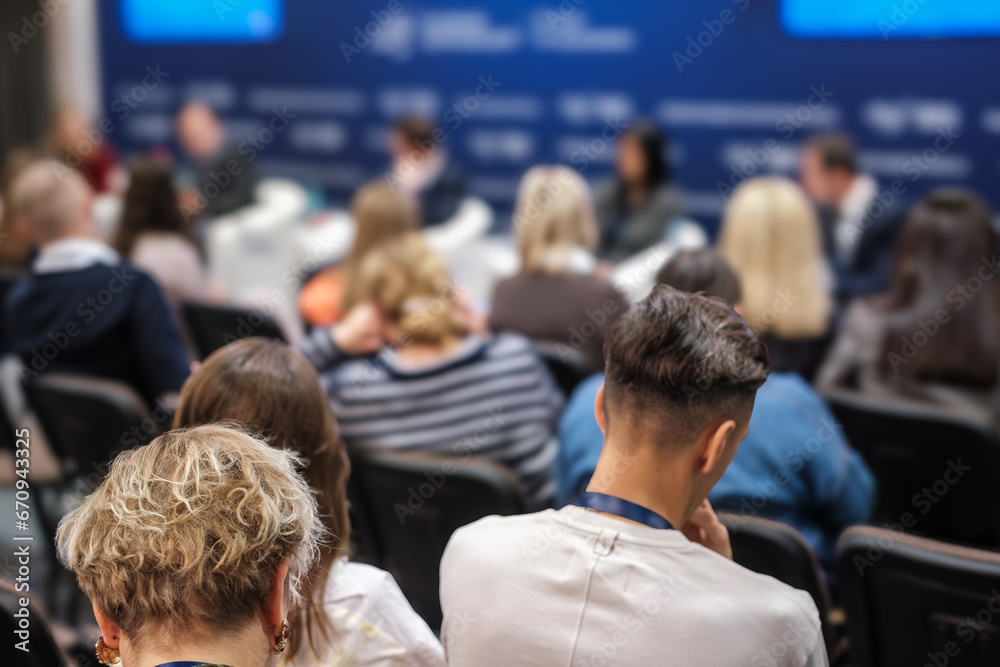 Obraz premium Back view of business people attending conference meeting at export forum