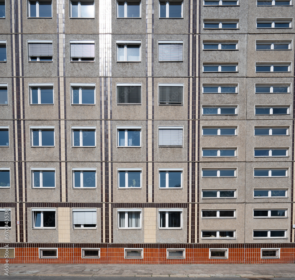 Facade of the socialistic panel grey with orange old building with windows in Berlin, Germany