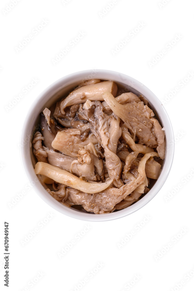 Delicious spicy mushrooms sliced and cooked in Korean style on a ceramic plate Delicious spicy mushrooms sliced and cooked in Korean style on a ceramic plate