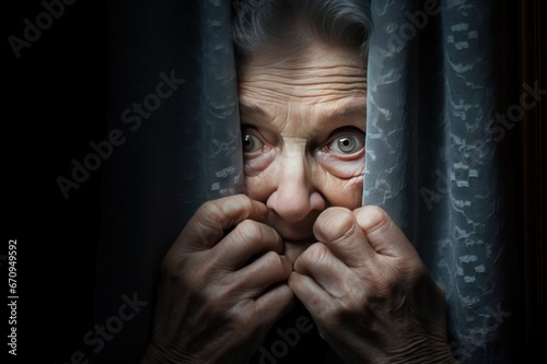 senior elderly woman watching and peeping on neighbors through window closeup. Home security concept.  photo