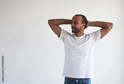 afro man wear white t-shirt hands head weekend rest pause after hard working isolated on grey background