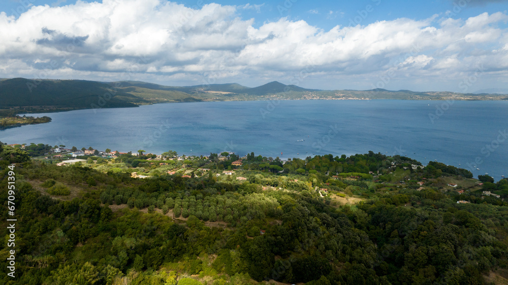 Aerial view of Lake Bracciano, originally also called Lake Sabatino. It is a lake of volcanic and tectonic origin, located in the metropolitan city of Rome and surrounded by the Sabatini Mountains.