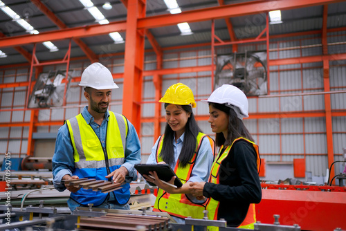 Blue collar worker work at metal sheet factory.