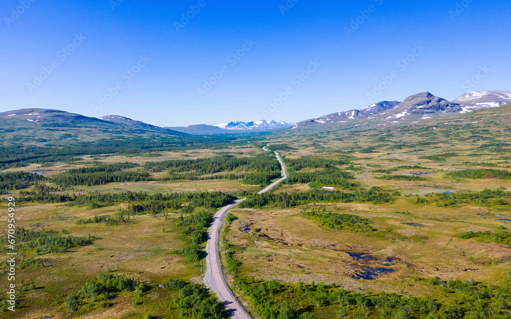 Fototapeta premium Road leading through breathtaking landscape in Sweden near Handöl