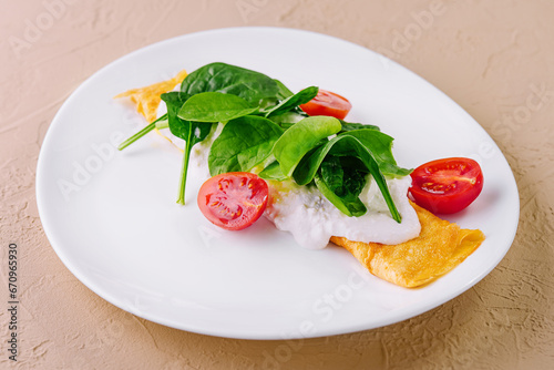 Omelet with tomatoes and herbs on a plate