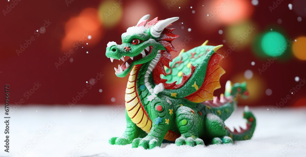 Green dragon figurine on a snowy white surface. Free space for product placement or advertising text.