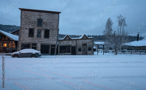 Old abandoned wooden buildings on a snowy street in Dawson City  Yukon  Canada