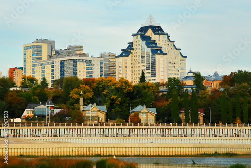 Beautiful view of the city from the Belaya River to the city of Ufa. Motor ships, boats on the water.Translation of the text - "Discounts on an apartment in Ufa".Bashkiria, Russia.Ufa. 