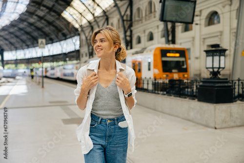 Lovely happy european woman with backpack wearing t-shirt and jeans is going to travel 