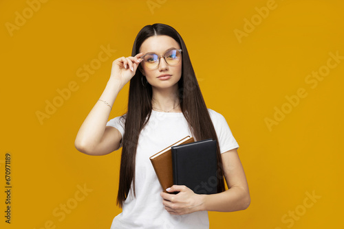 Attractive young woman with books in hands