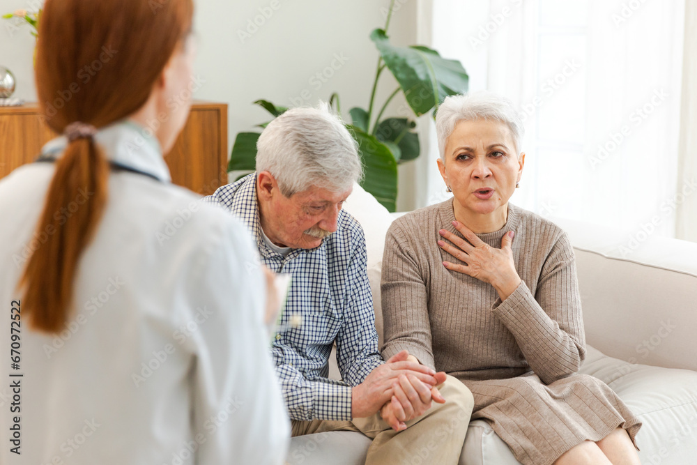 Female doctor examining older senior couple in doctor office or at home ...