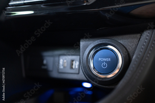 Blue power ignition button to start keyless ignition hybrid car engine Power button on a vehicle. photo