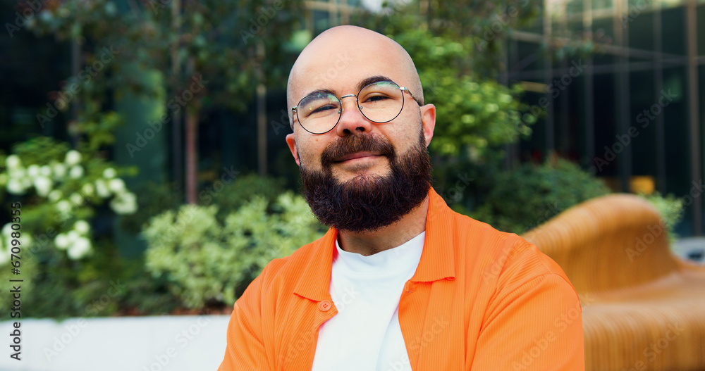 Portrait of handsome man wearing glasses standing at the street and looking camera. Close up hipster face thoughtful smiling handsome man. Portrait of handsome man wearing glasses standing at the street and looking camera. Close up hipster face thoughtful smiling handsome man.
