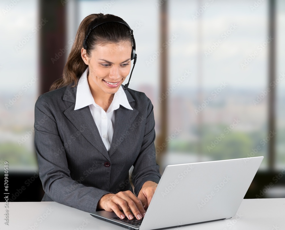 Portrait of business woman, using headset for online communication Portrait of business woman, using headset for online communication