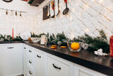 Cozy flat apartment photo studio room kitchen utensils gifts presents garlands, candles decorated toys balls interior New Year lights glowing bokeh
