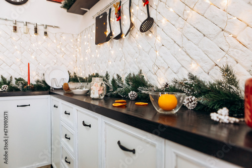 Cozy flat apartment photo studio room kitchen utensils gifts presents garlands, candles decorated toys balls interior New Year lights glowing bokeh  © Volodymyr