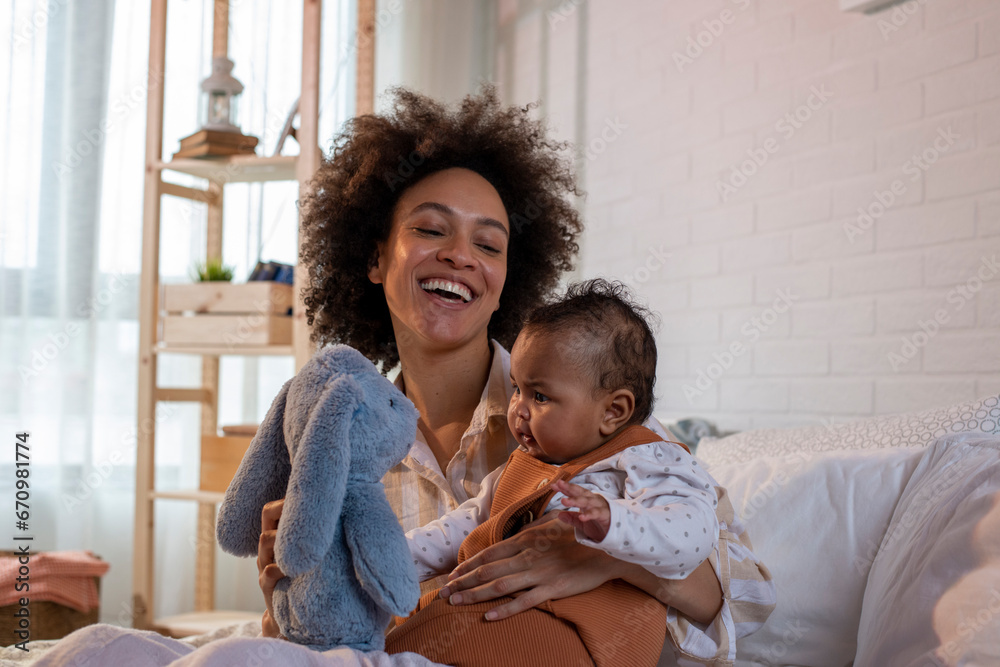 Smiling mother with baby and a toy Smiling mother with baby and a toy