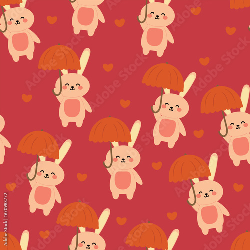 Cute rabbit wearing an umbrella cartoon seamless pattern. cute animal wallpaper illustrations for gift wrapping paper