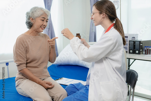 Female doctor with clipboard talking with elderly female patient at hospital Senior woman or doctor with digital tablet Consult or plan treatment to treat medical professionals with female patients.