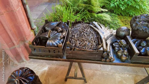 Panning over metal sculpture depicting different types of food at Basel Minster, Switzerland. photo