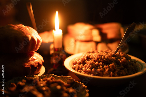 Christmas Eve in a Ukrainian family. Kutya on the table and a lighted candle. photo