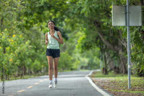 Stylish female runners in modern attire, discover serenity. Reenergize amid jogging the parkway.