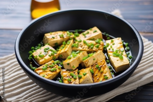 tofu steaks in a bowl soaking in teriyaki marinade